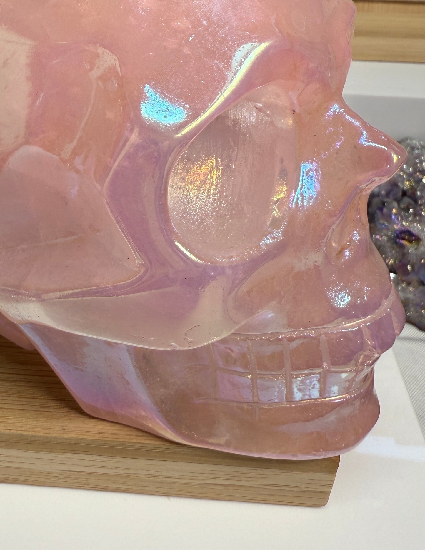 Large Pink Aura Rose Quartz crystal skull, measuring approximately 5 x 5.5 inches and weighing 4 lbs. Features soft pink coloration and a glowing, iridescent surface. Displayed as a carved decorative stone with heart-focused elegance.