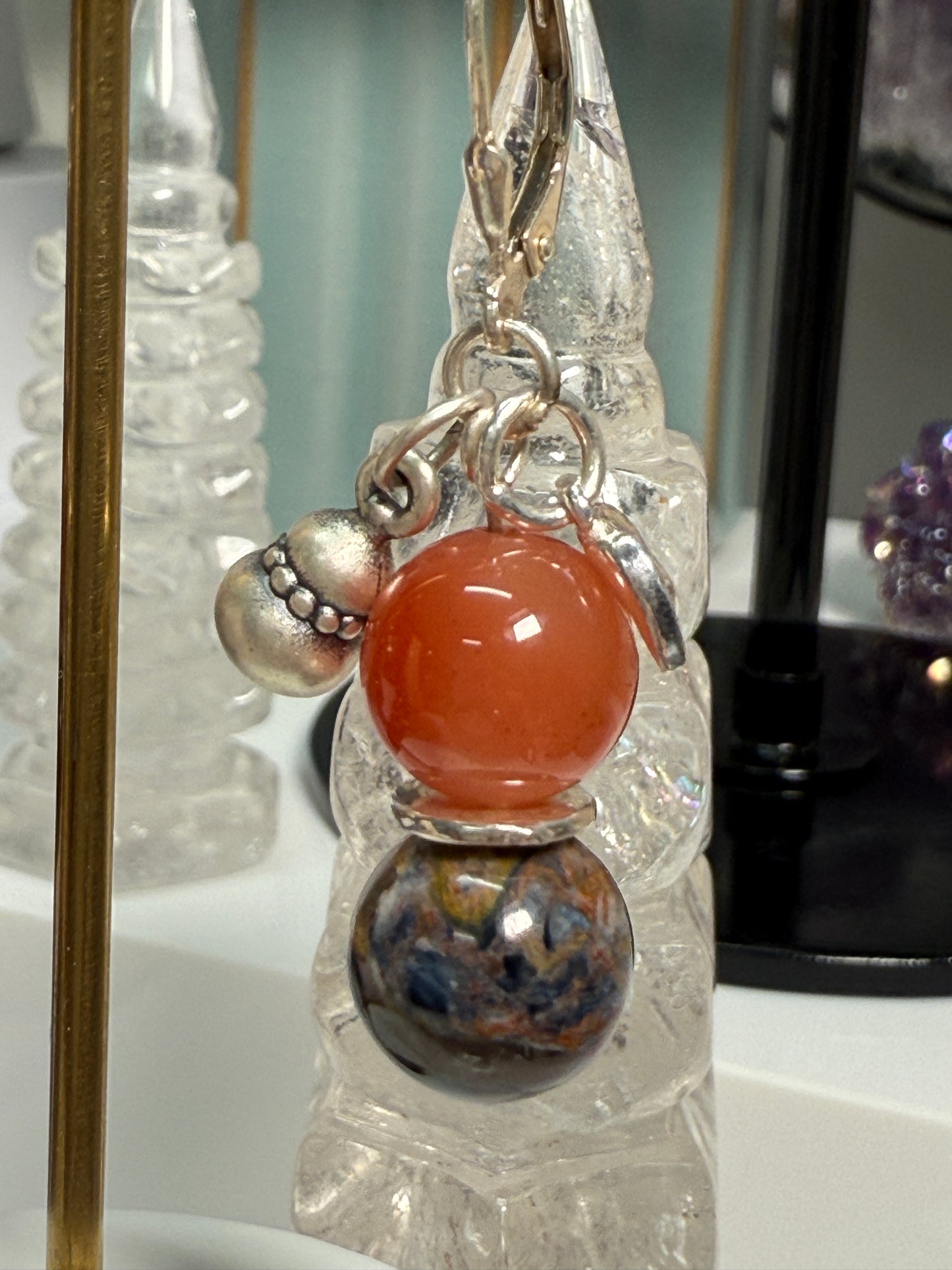 Pair of crystal earrings combining South Red Agate and Pietersite, with silver bamboo leaf and gourd details. Photographed as warm, harvest-themed jewelry.