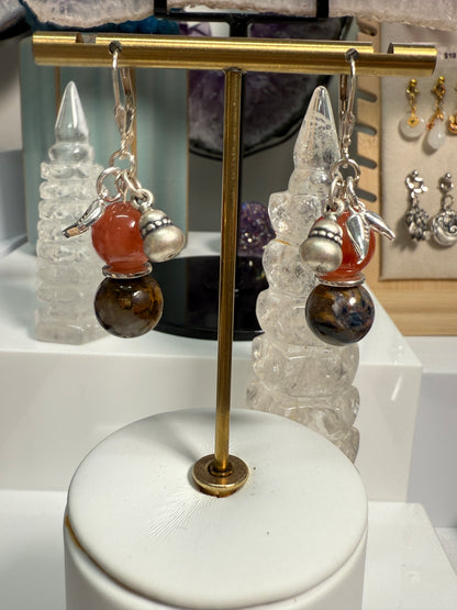 Pair of crystal earrings combining South Red Agate and Pietersite, with silver bamboo leaf and gourd details. Photographed as warm, harvest-themed jewelry.