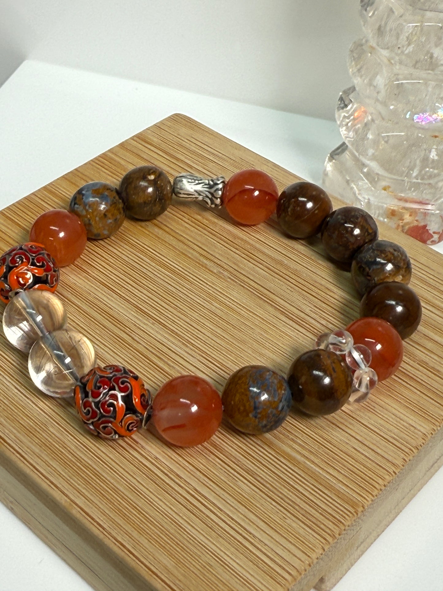 Crystal bracelet featuring South Red Agate, Pietersite, Rutile-in-Quartz, and Brown Opal, with 925 sterling silver cabbage and enameled beads, accented by a clear quartz ring. A sculptural fine jewelry piece symbolizing growth, clarity, and inner resilience.