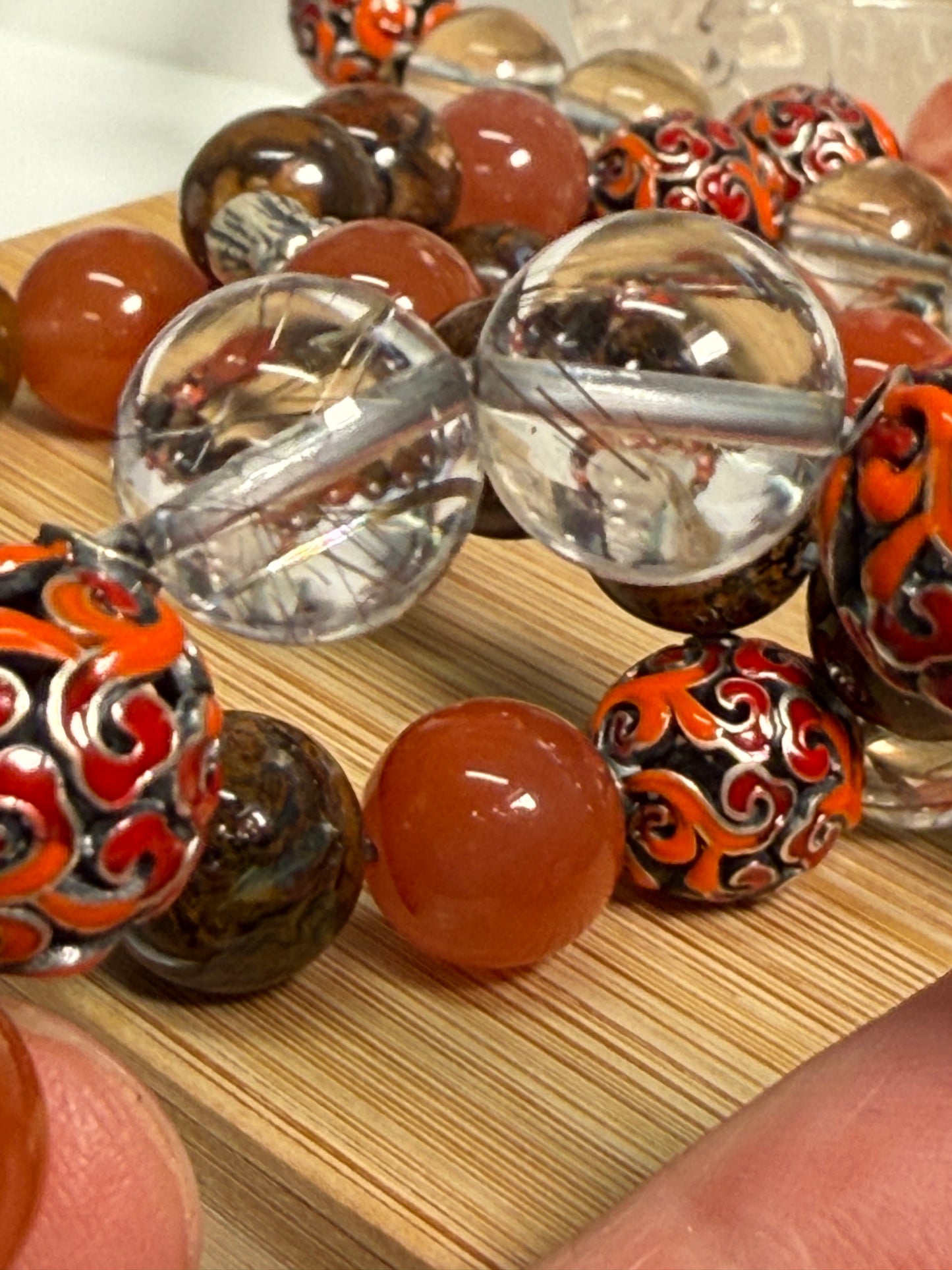 Crystal bracelet featuring South Red Agate, Pietersite, Rutile-in-Quartz, and Brown Opal, with 925 sterling silver cabbage and enameled beads, accented by a clear quartz ring. A sculptural fine jewelry piece symbolizing growth, clarity, and inner resilience.